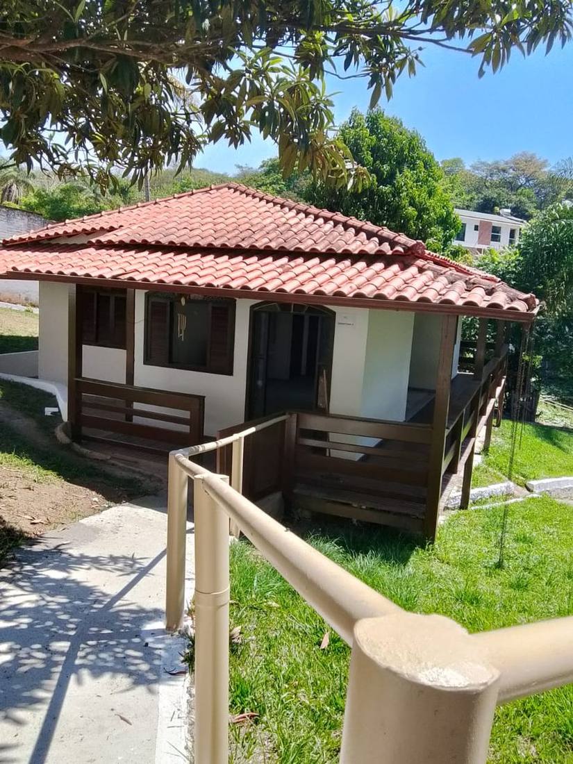 Chalé branco com deck de madeira na clínica de reabilitação